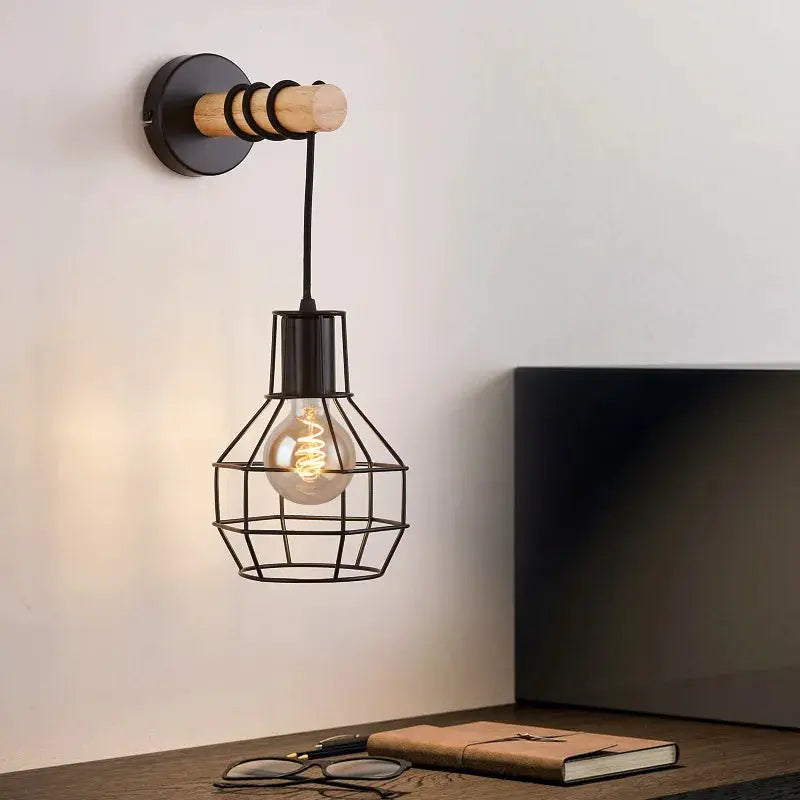 China Wall Sconce by Simples Market - black metal cage shade with wooden base bracket and exposed Edison bulb
