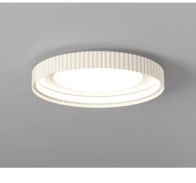 Round metal LED ceiling light with a ribbed white outer ring.