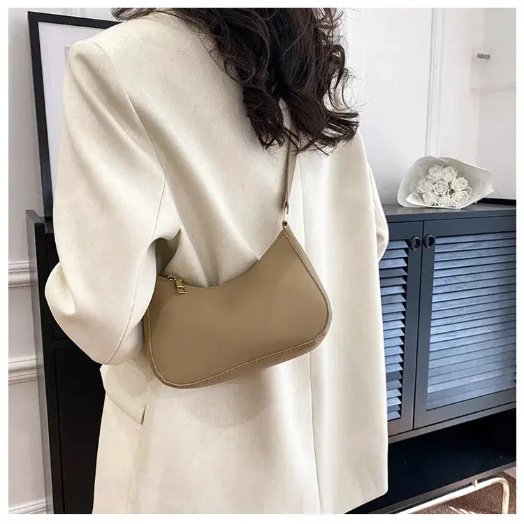 Shoulder bag by Simples Market in tan, curved square silhouette.