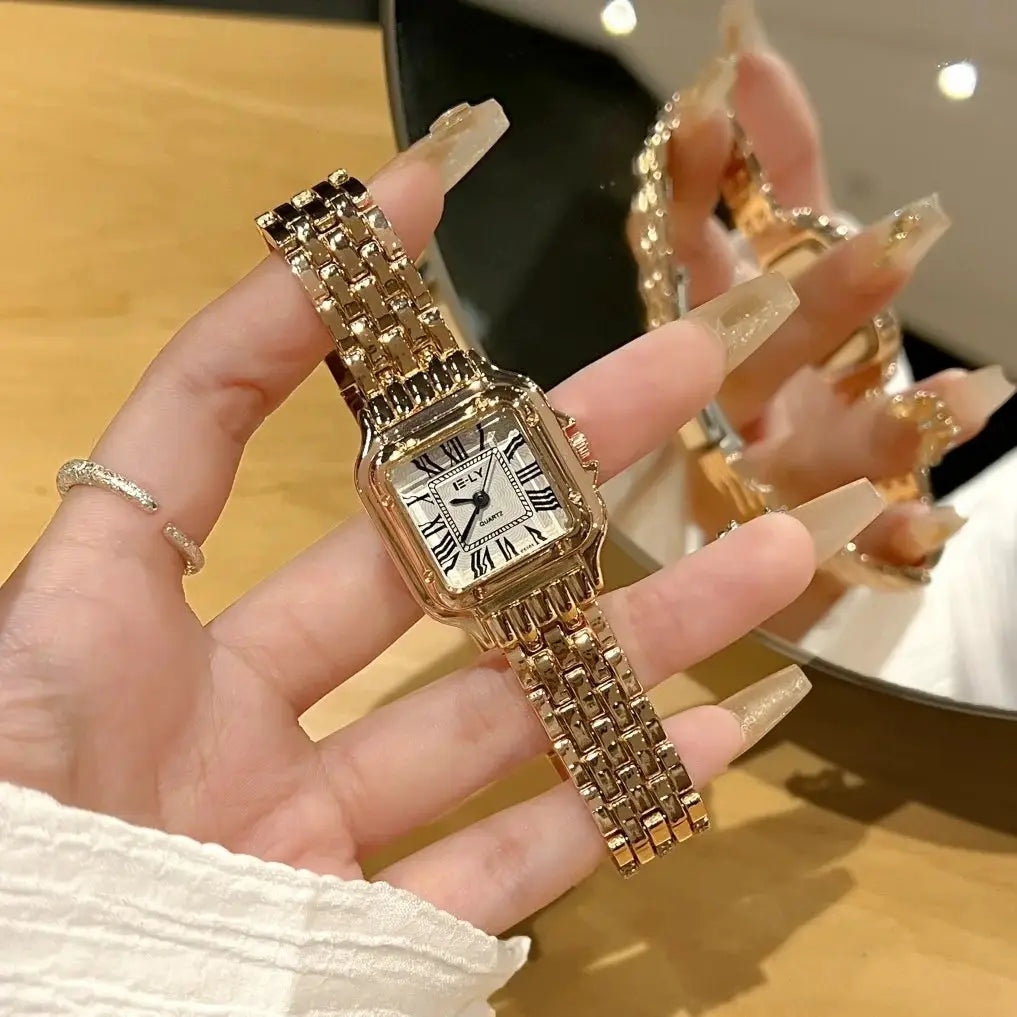Women’s gold-tone stainless steel quartz wristwatch with a rectangular Roman numeral dial and linked bracelet.