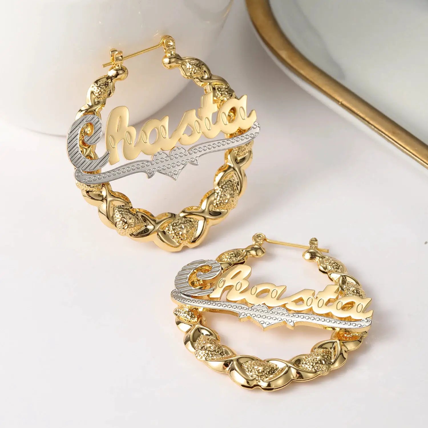 Two-tone gold hoop earrings with a custom scripted name plaque on a dotted silver bar and bamboo-link hoops (set of 2).