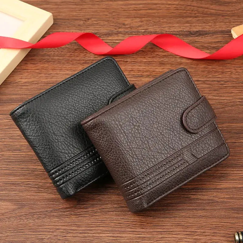 Men's slim leather bifold wallets, two by Simples Market, in black and brown with card slots on wood surface