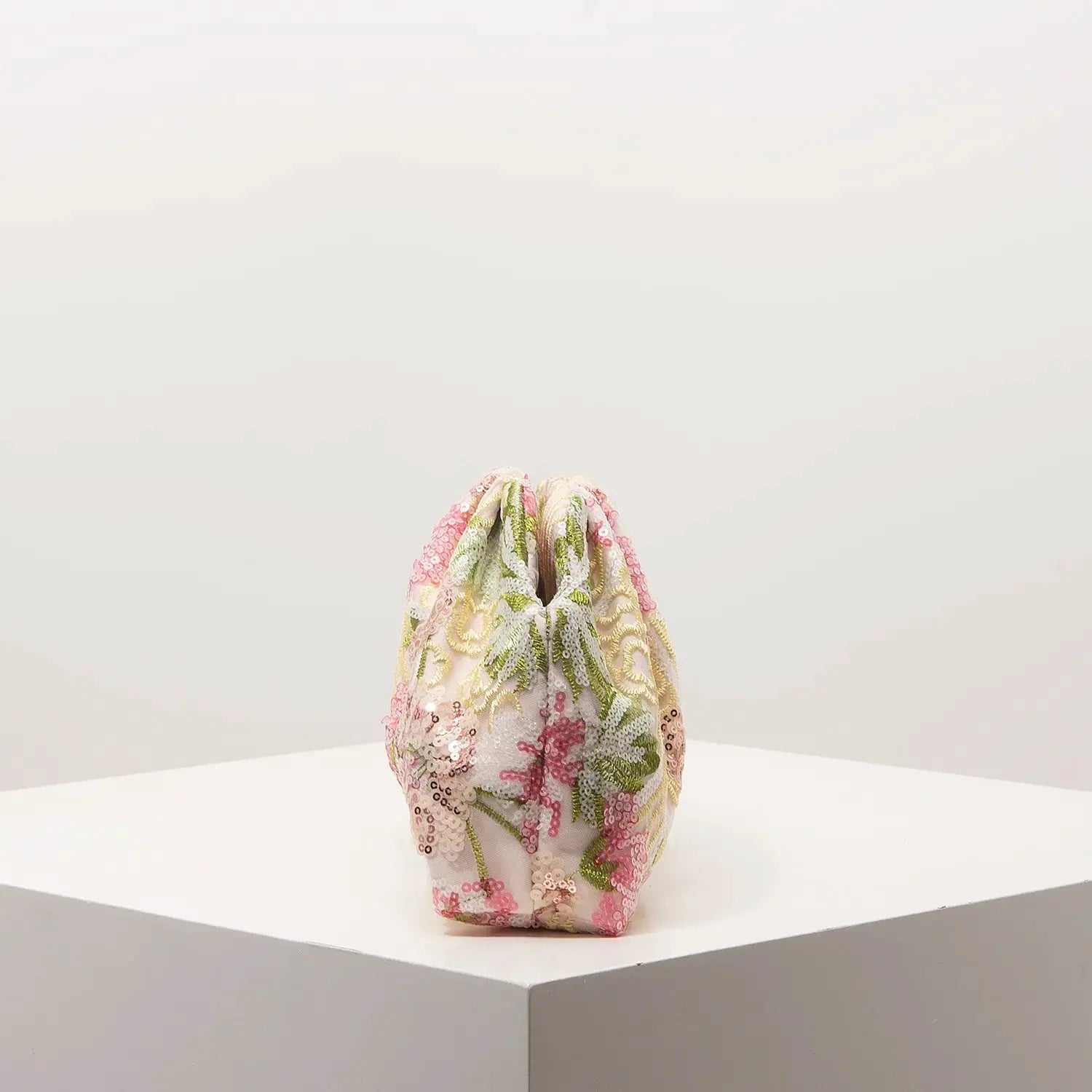 Clutch bag with multicolor sequin floral embroidery on pale fabric