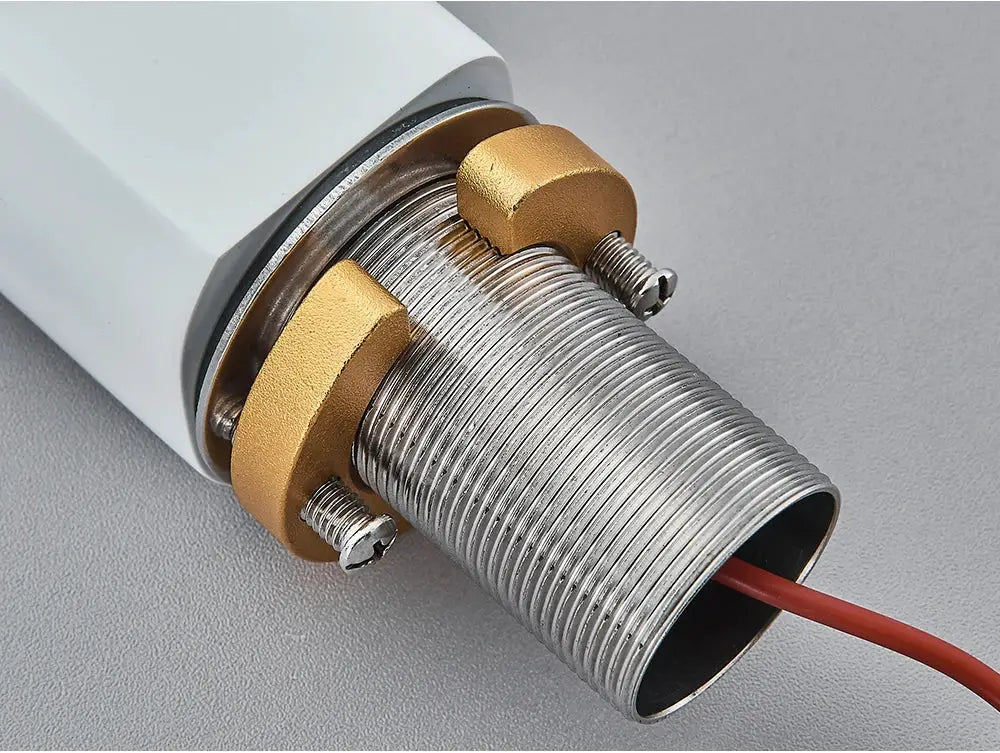 White smart sensor basin faucet body with a threaded metal outlet, brass mounting nuts, and red wiring.