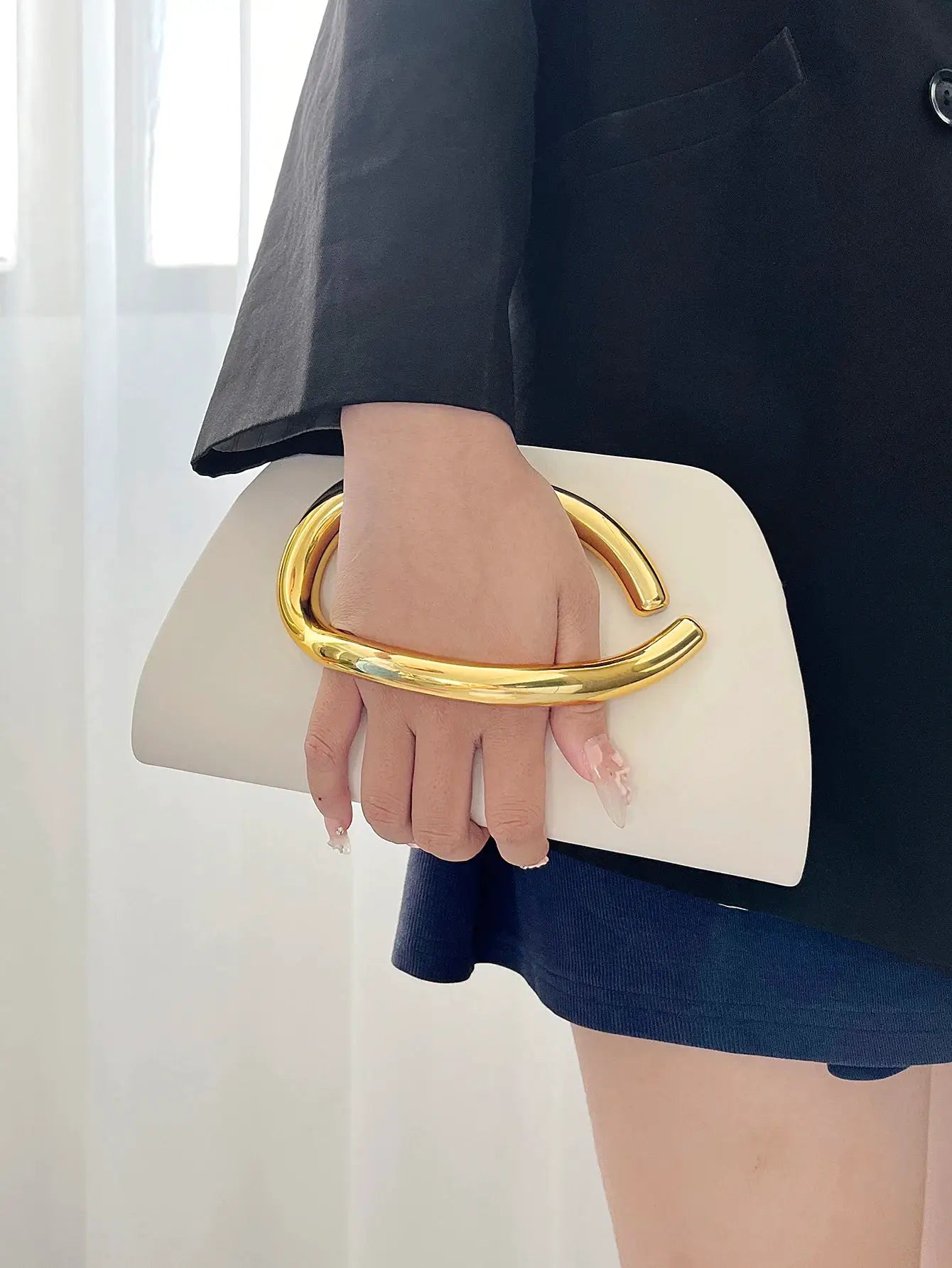 White box clutch with oversized gold-tone curved handle for evening events