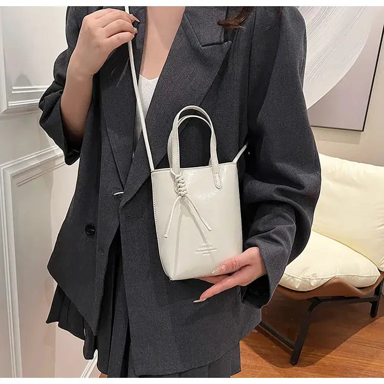 Mini PU leather crossbody bag by Simples Market in white with short handles and long strap
