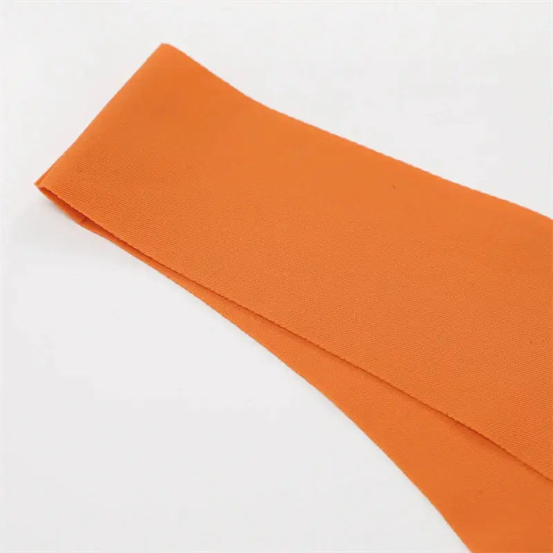 Orange ice-silk seamless women's thong underwear, low-rise fabric close-up