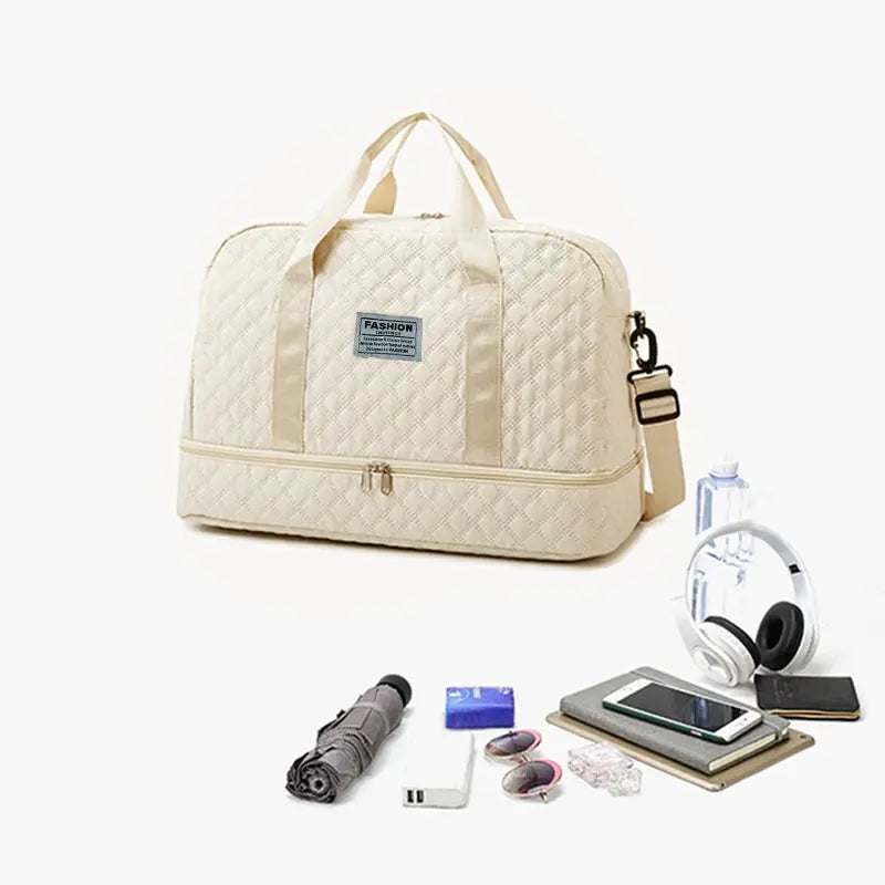 Beige quilted duffle bag with handles and a detachable shoulder strap, roomy travel bag.