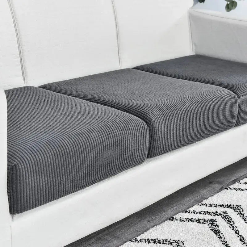 Simples Market elastic sofa cover in charcoal gray, ribbed fabric, fits three seat cushions on white sofa