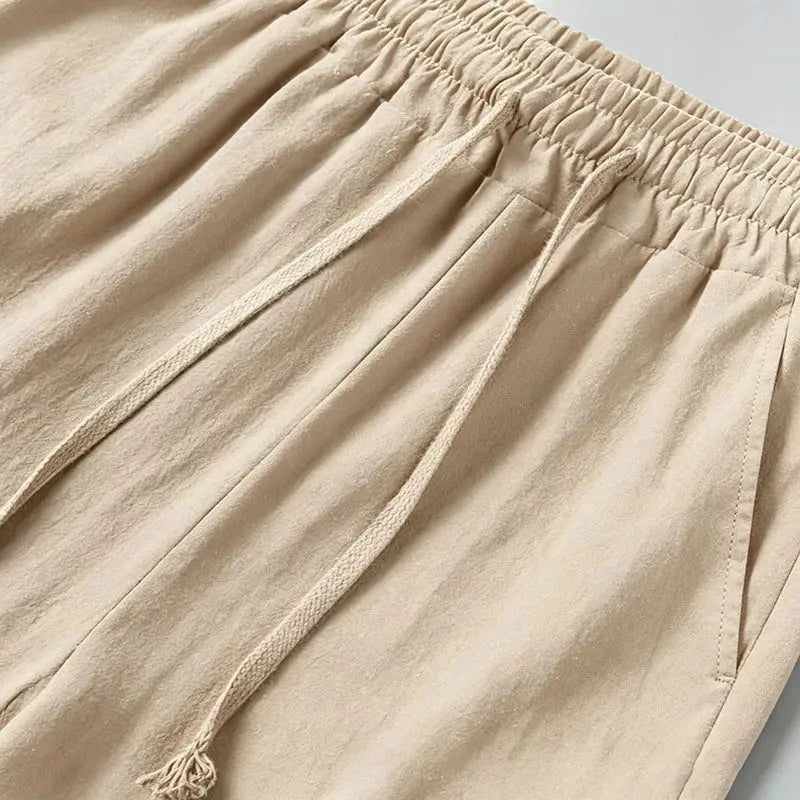 Men's beige cotton-linen blend cargo jogger pants with elastic waist, drawstring, and multiple pockets