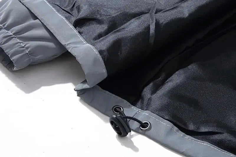 Black reflective jacket with gray cuffs, polyester fabric and drawstring toggle