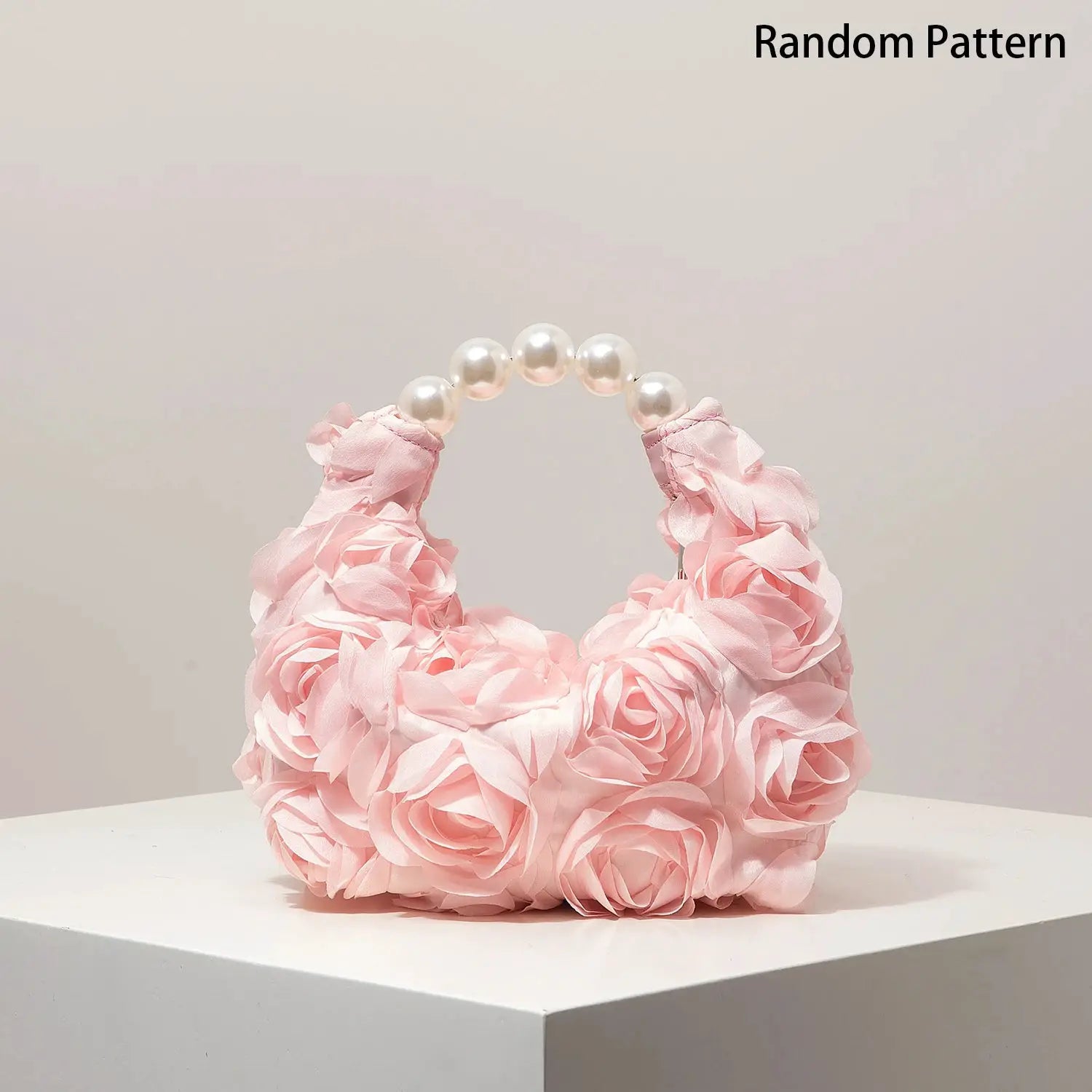Pink rose-covered clutch with pearl bead handle for elegant evening wear
