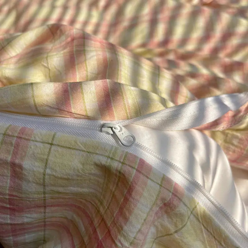 Cotton striped duvet cover set with pillowcases; pastel pink, yellow and green plaid, zipper closure.
