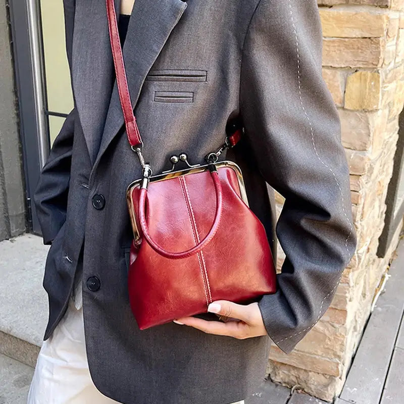 Vintage-style women's PU leather handbag with crossbody strap in burgundy red