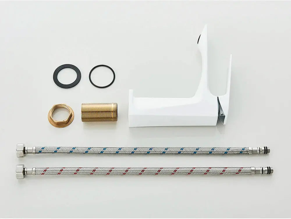White deck-mounted bathroom faucet with two braided hoses and mounting hardware by Simples Market