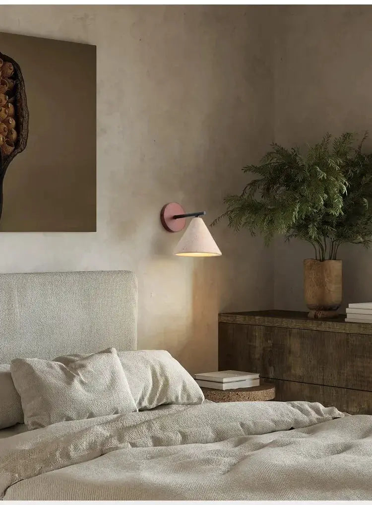 Natural stone wall lamp travertine sconce with pink backplate and beige conical shade, warm LED lighting for bedroom
