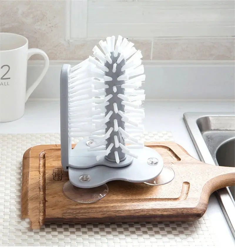 Cup scrubber brush with white bristles on gray base; 2-in-1 suction cup cleaning gadget for mugs
