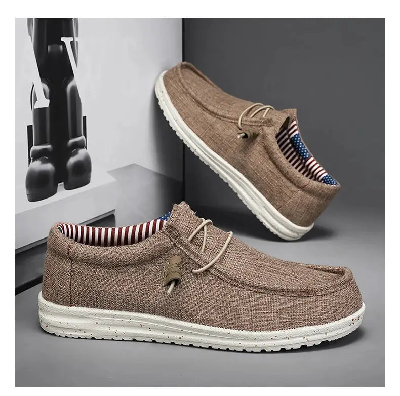 Men's casual canvas loafers in tan with white vulcanized sole and striped lining; two shoes shown.