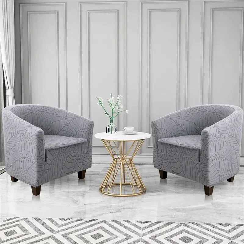 Elastic club chair covers with grey leaves jacquard; set of two armchairs with a round white table