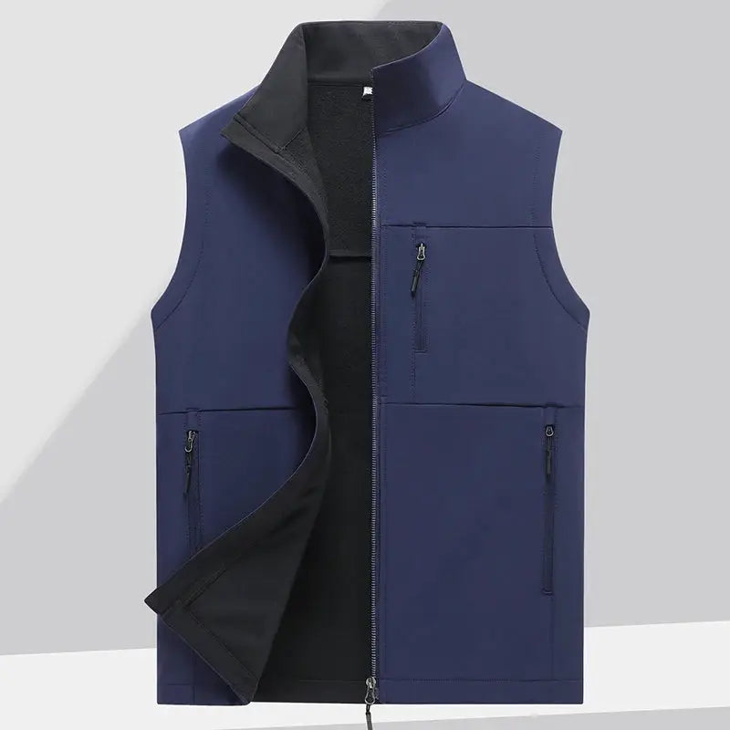 Men's navy blue soft-shell vest with full front zipper, black fleece lining, chest pocket and two zip pockets