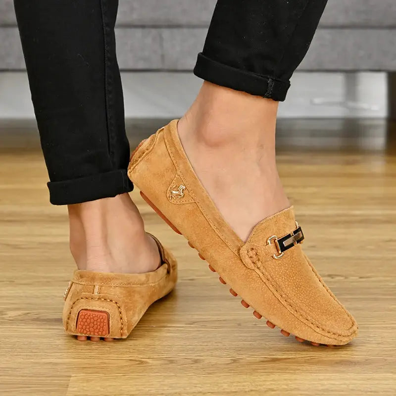 Pair of YRZL men's tan suede loafers by Simples Market, slip-on driving moccasins with metal buckle.