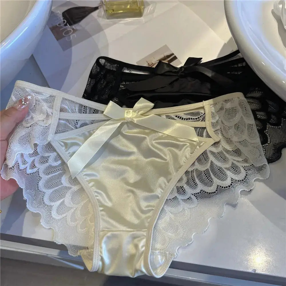 Simples Market women's lace panties; white satin front with scalloped lace sides and bow, plus black lace panty behind.