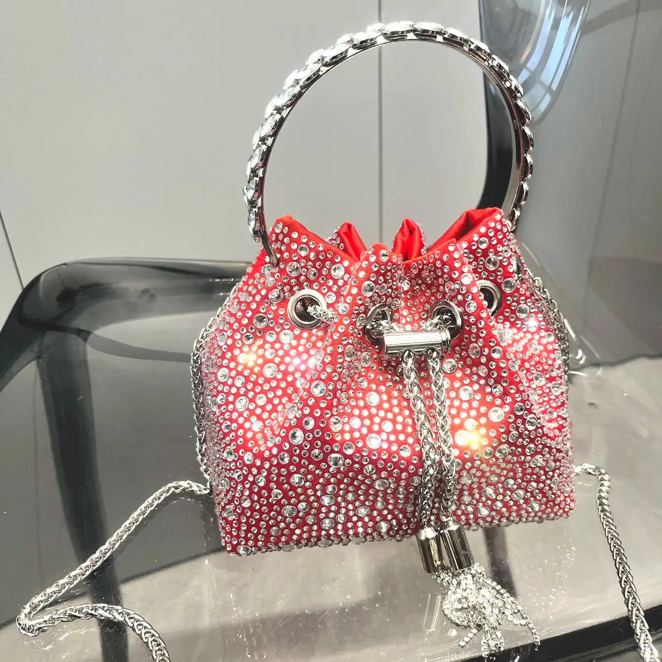 Red rhinestone evening clutch bag by Simples Market with crystal surface, silver chain strap and crystal ring handle
