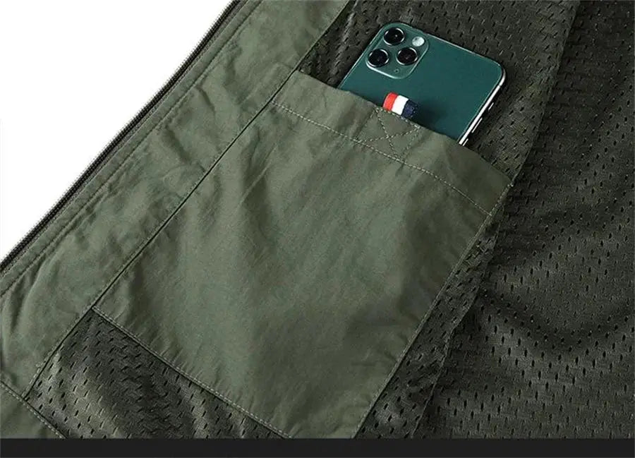 Sleeveless cargo vest in olive green with front pocket holding a phone