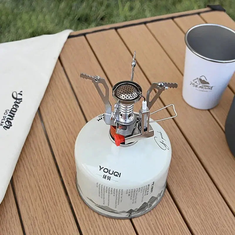 Gas camping stove on white YOUQI fuel canister; aluminum alloy, portable Simples Market
