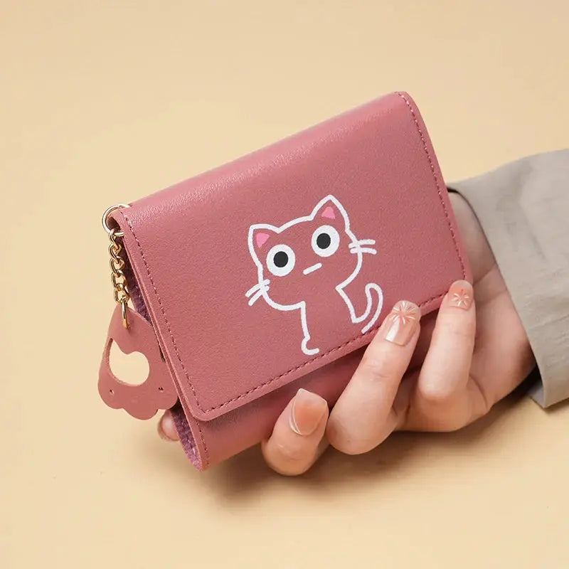 Pink short-style purse with white cartoon cat, compact wallet with card slots and gold chain charm