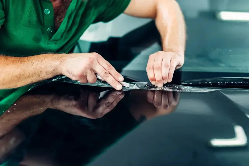 Car gloss PPF clear protection vinyl film by Simples Market applied to a dark car hood