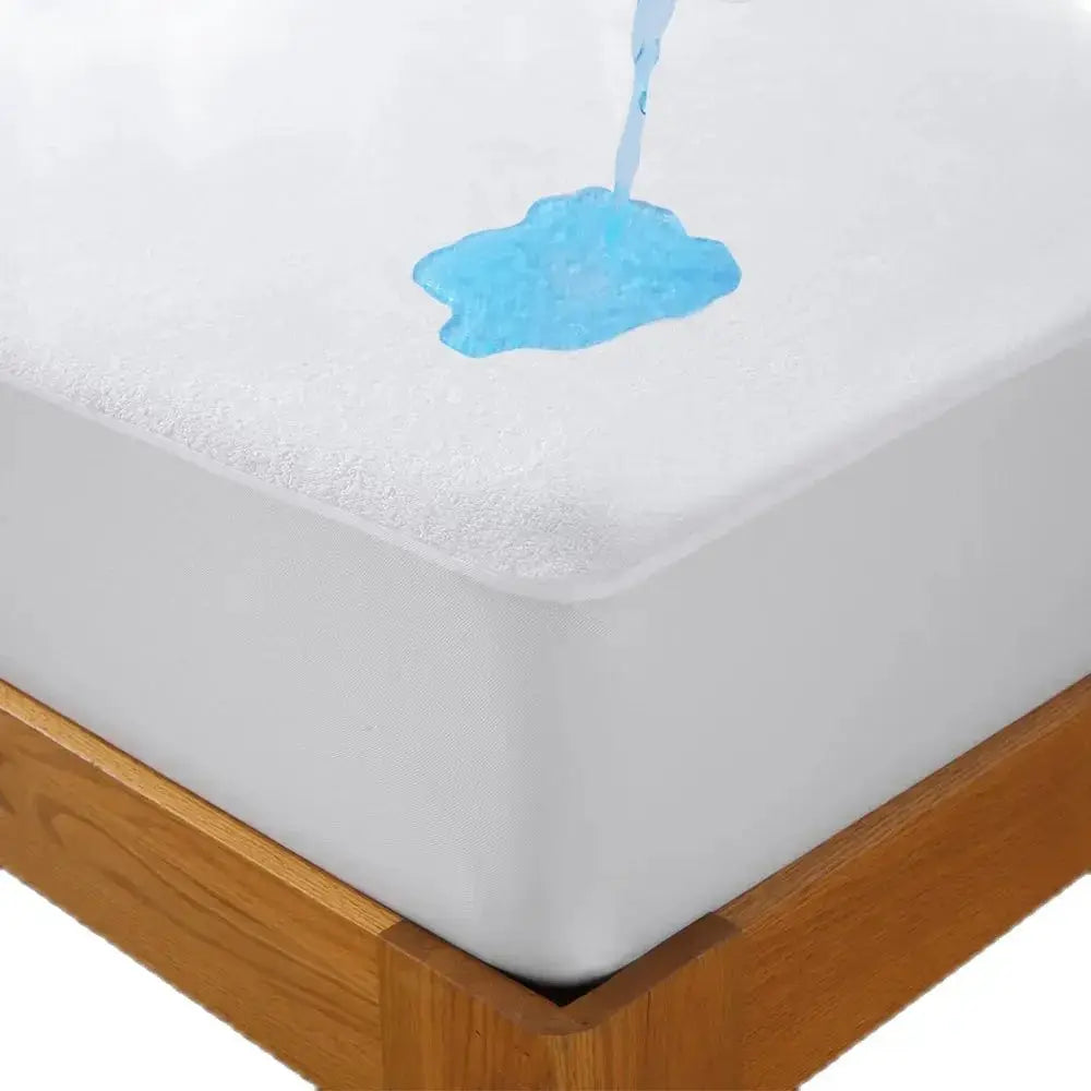 Waterproof terry cloth fitted sheet with elastic, deep-pocket mattress protector on a wooden bed