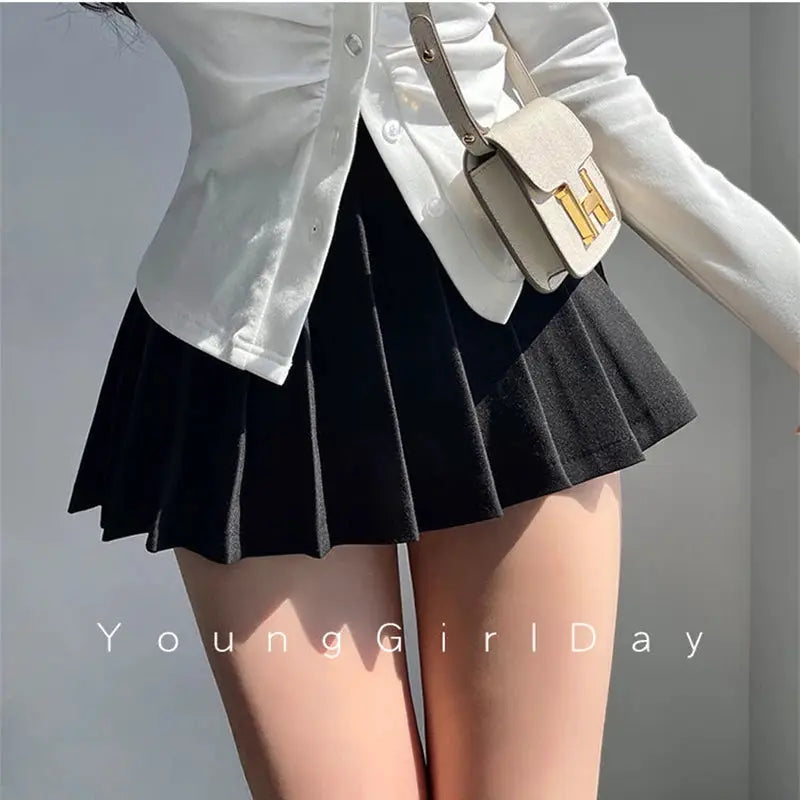 Black pleated mini skirt with beige crossbody bag; 2-piece look, YoungGirlDay watermark visible