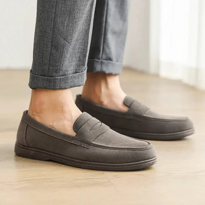 Pair of men's charcoal gray suede slip-on loafers with cushioned, non-slip sole for casual daily walking