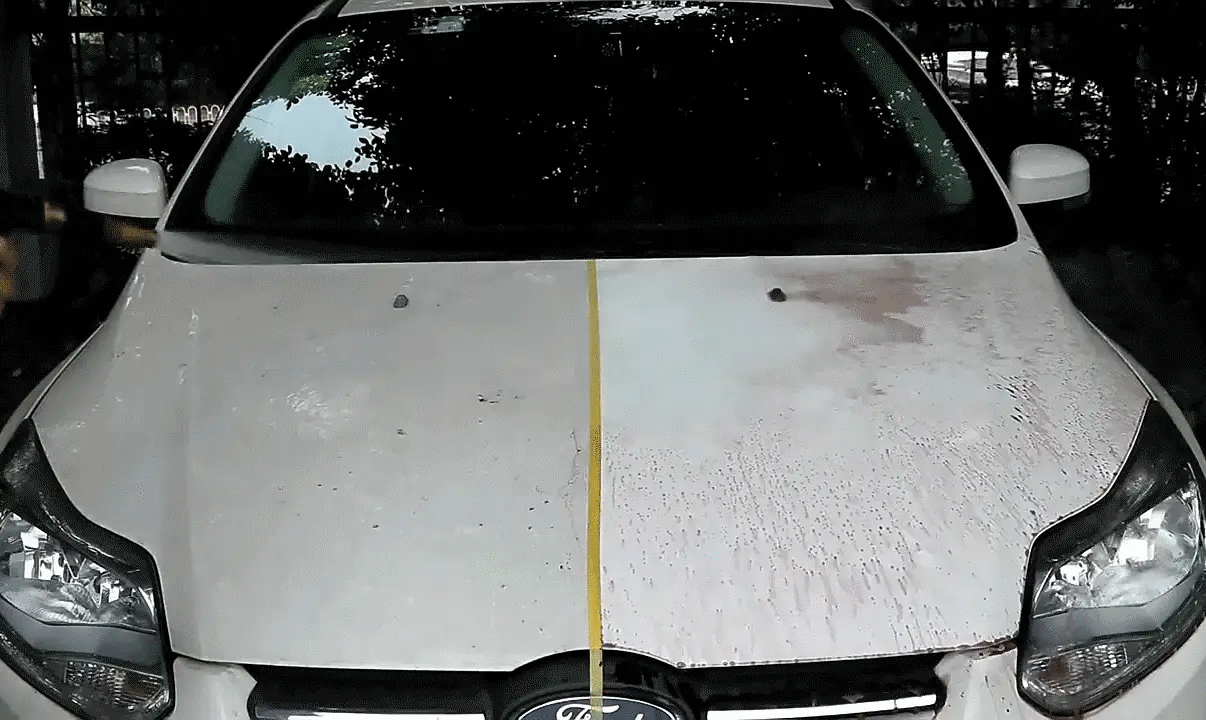 HGKJ car paint and wheel rust remover spray on a white car hood showing rust spots and grime