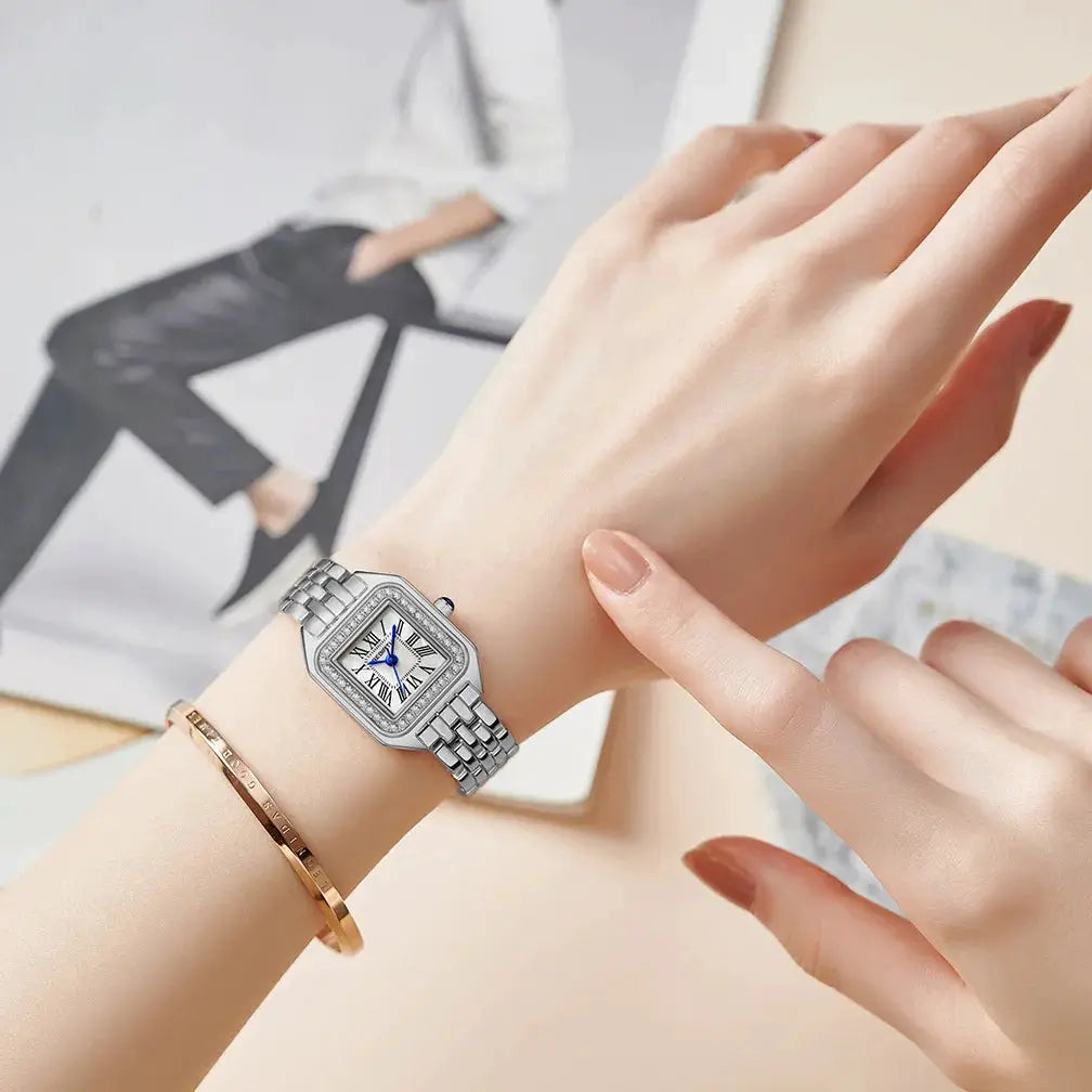 Women’s stainless steel wristwatch with a silver square dial, blue hands and Roman numerals; paired with a rose-gold bracelet.