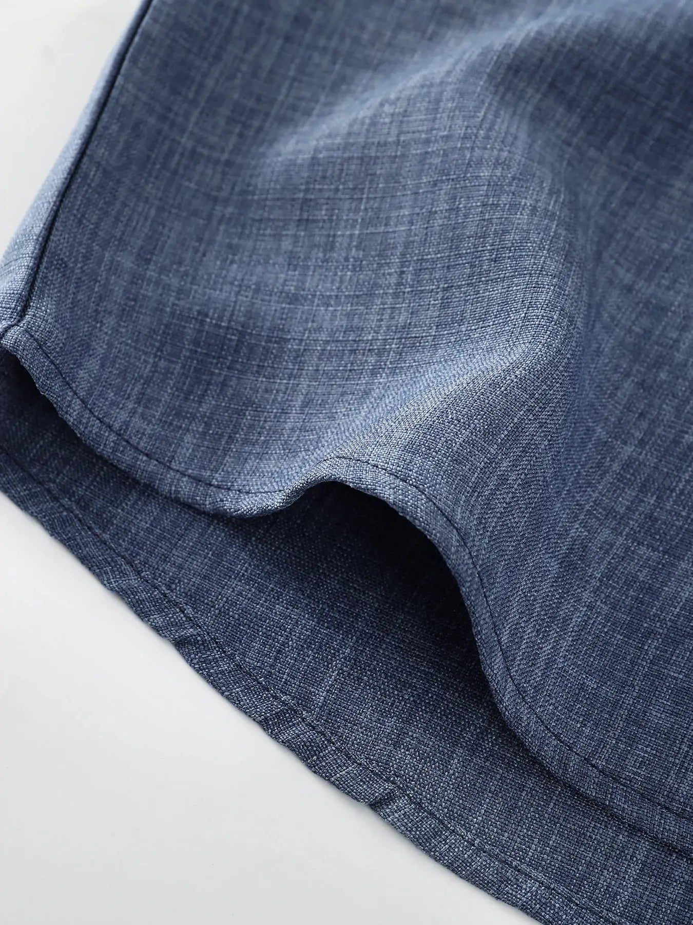 Men's blue linen short-sleeve shirt sleeve close-up with hem stitching