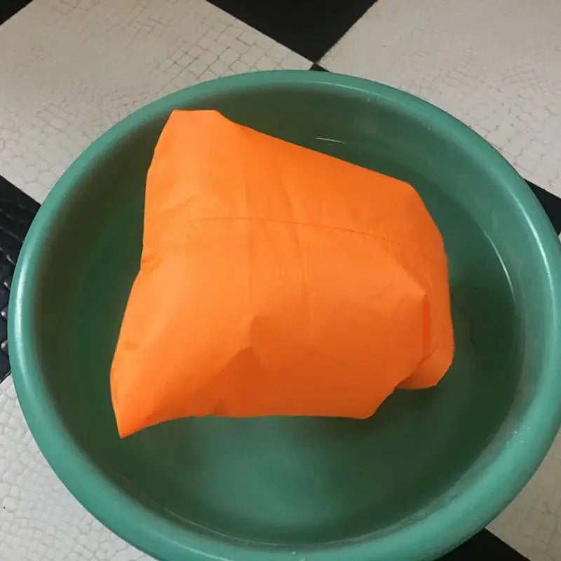 Waterproof outdoor dry bag set showcased in water, demonstrating its waterproof capabilities and vibrant orange color.