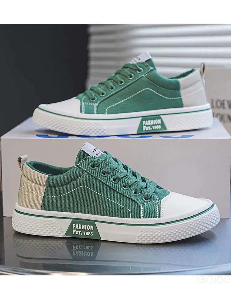 Two green canvas sneakers for men with white toe caps, beige heel, and white sole on a display box