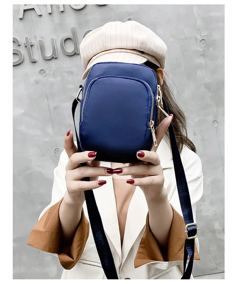 Blue Simples Market waterproof mini crossbody bag with zip pockets and adjustable strap.