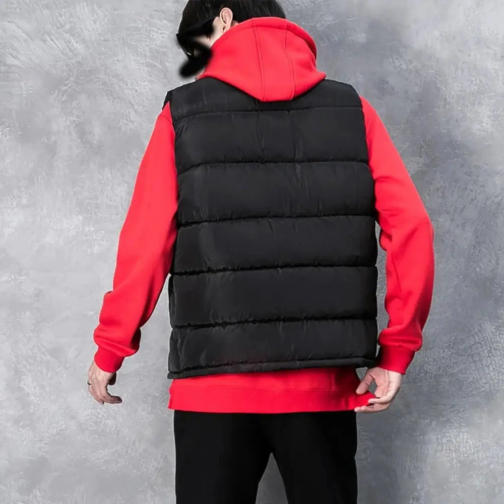 Men's black sleeveless puffer vest jacket with stand collar worn over red hoodie
