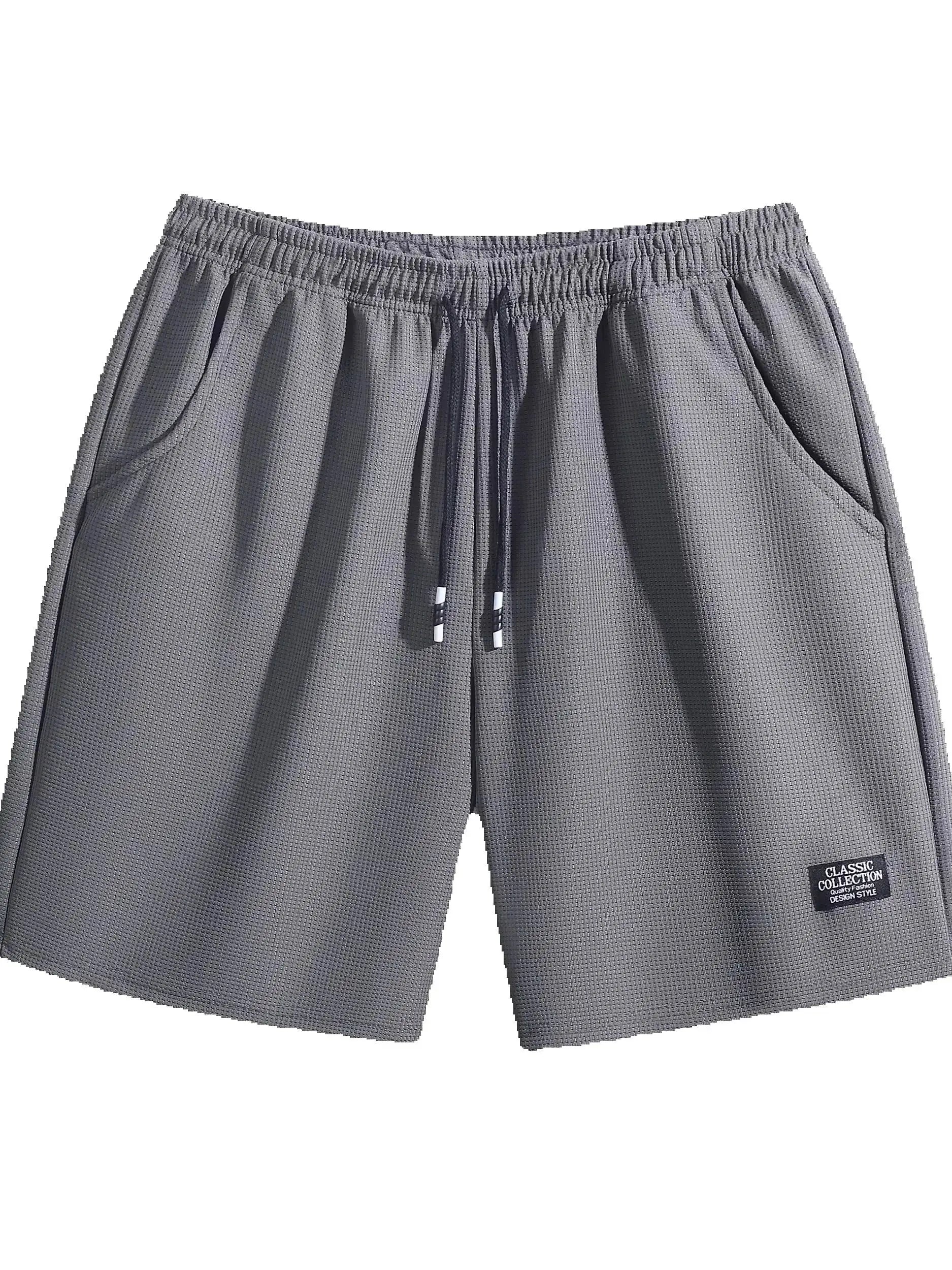Pair of men's grey textured shorts with elastic waistband, drawstring, and side pockets; CLASSIC COLLECTION label