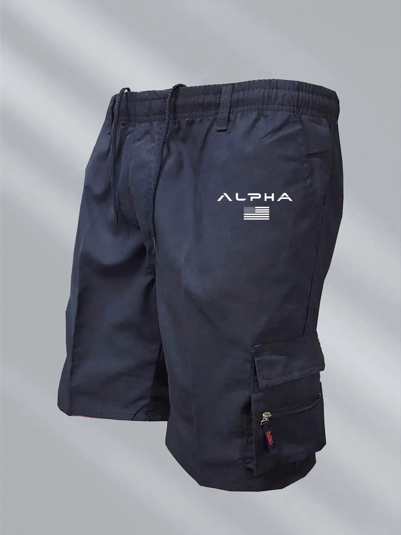 Men's navy cargo shorts with large pockets, drawstring waist, Alpha logo and US flag.