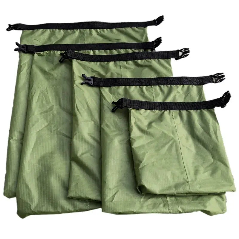 Waterproof dry bag set featuring five green bags with black straps for outdoor protection.