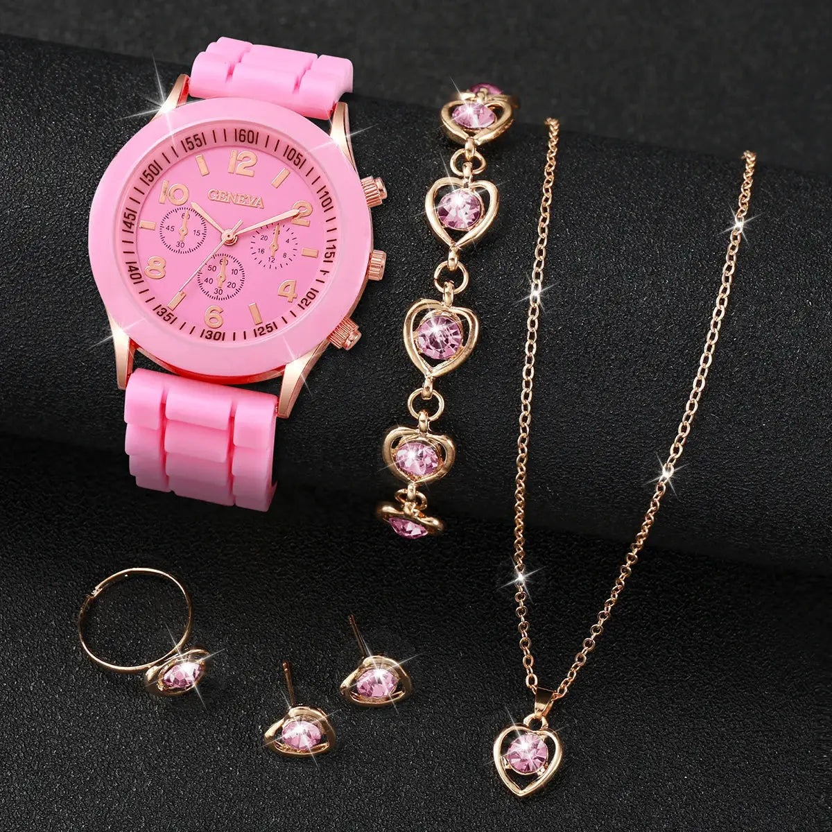 Pink silicone watch with rose-gold case and pink jewelry set including ring, earrings, bracelet, and pendant necklace.