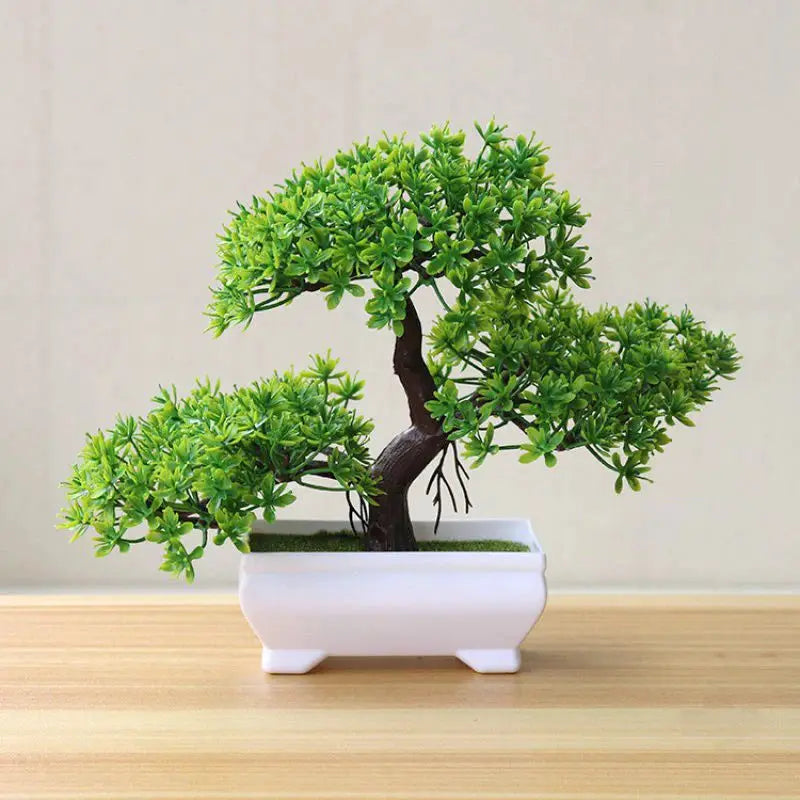Artificial bonsai tree in a white rectangular pot with vibrant green leaves.