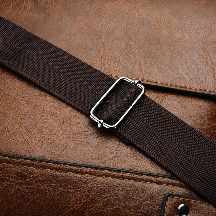 Shoulder bag by Simples Market with brown leather body and dark brown crossbody strap with silver buckle