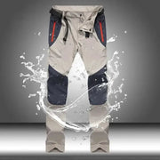 Men's tactical waterproof cargo pants, beige with navy knee panels and red zip pockets, 4XL.