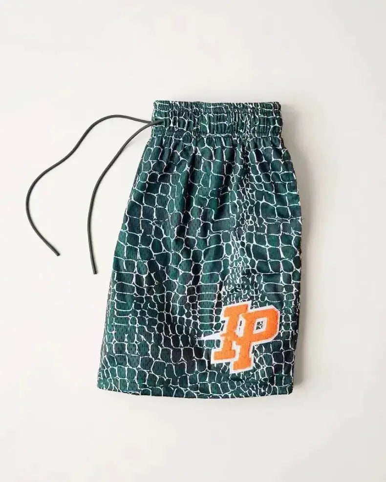 Men's mesh quick-dry shorts in green teal reptile print with orange HP logo and drawstring waistband.
