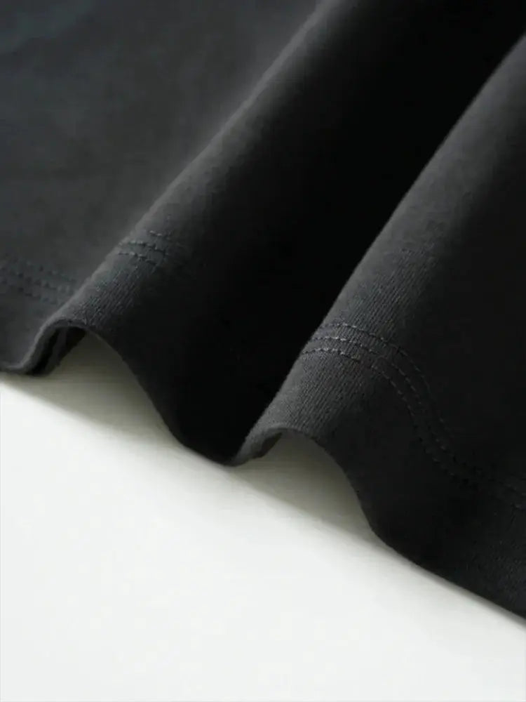 Cycling sweatpants fabric close-up in black with neat hem stitching detail